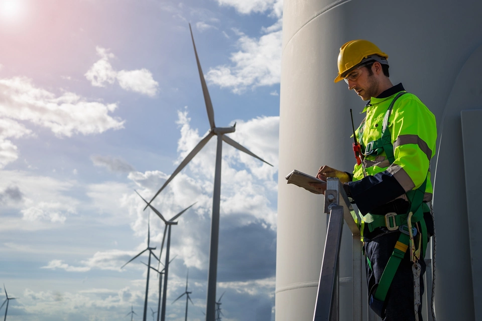 engineers are discussing maintenance of wind turbines. Clean energy. Alternative energy concept; Shutterstock ID 2340726169; purchase_order: Enterprise MARCOM; job: Public Relations Images; client: Various; other: Requested by Jacqueline Moreno