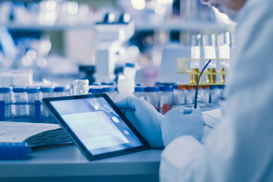 Senior Male Research Scientist is Using a Tablet Computer in a Modern High-Tech Laboratory. Genetics and Pharmaceutical Studies and Researches.