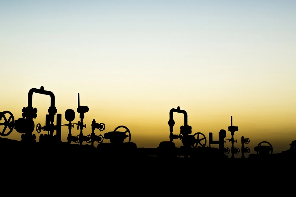 Sunset blue hour and silhouette of oilfield worker at oil well manifold  ; Shutterstock ID 531329203; purchase_order: Enterprise MARCOM; job: Emerson.com; client: Web; other: Requested by Susan Tencio