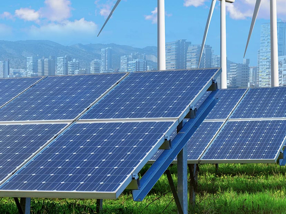 solar panels and wind turbines under blue sky and clouds with city on horizon