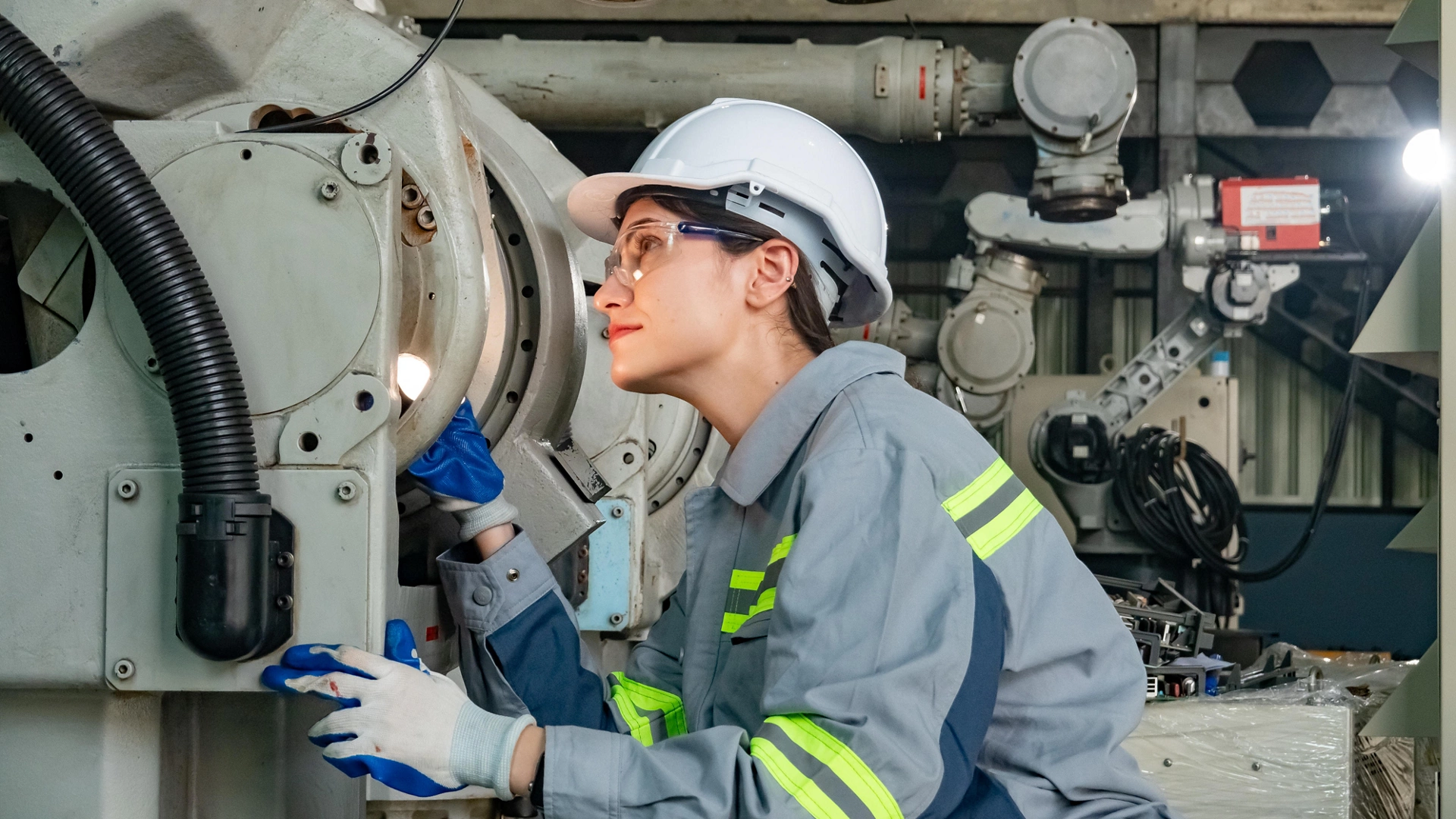 Engineers inspecting and check up machine of the automated arms machine welding robots at factory.