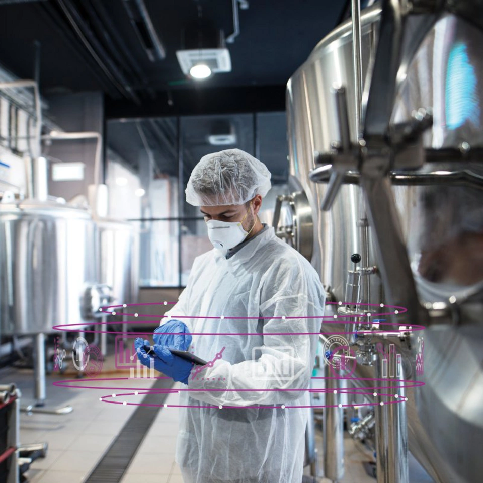 Life Sciences - Man in clean room PPE mask gloves booffant hat coverall lab coat biotech