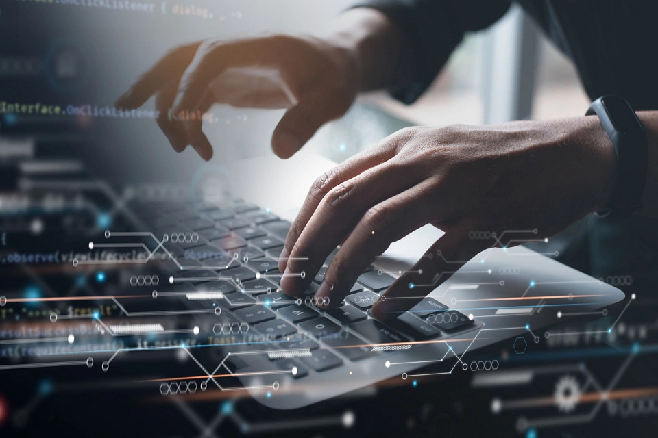 Digital technology, software development concept. Coding programmer, software engineer working on laptop with circuit board and javascript on virtual screen, internet of things IoT