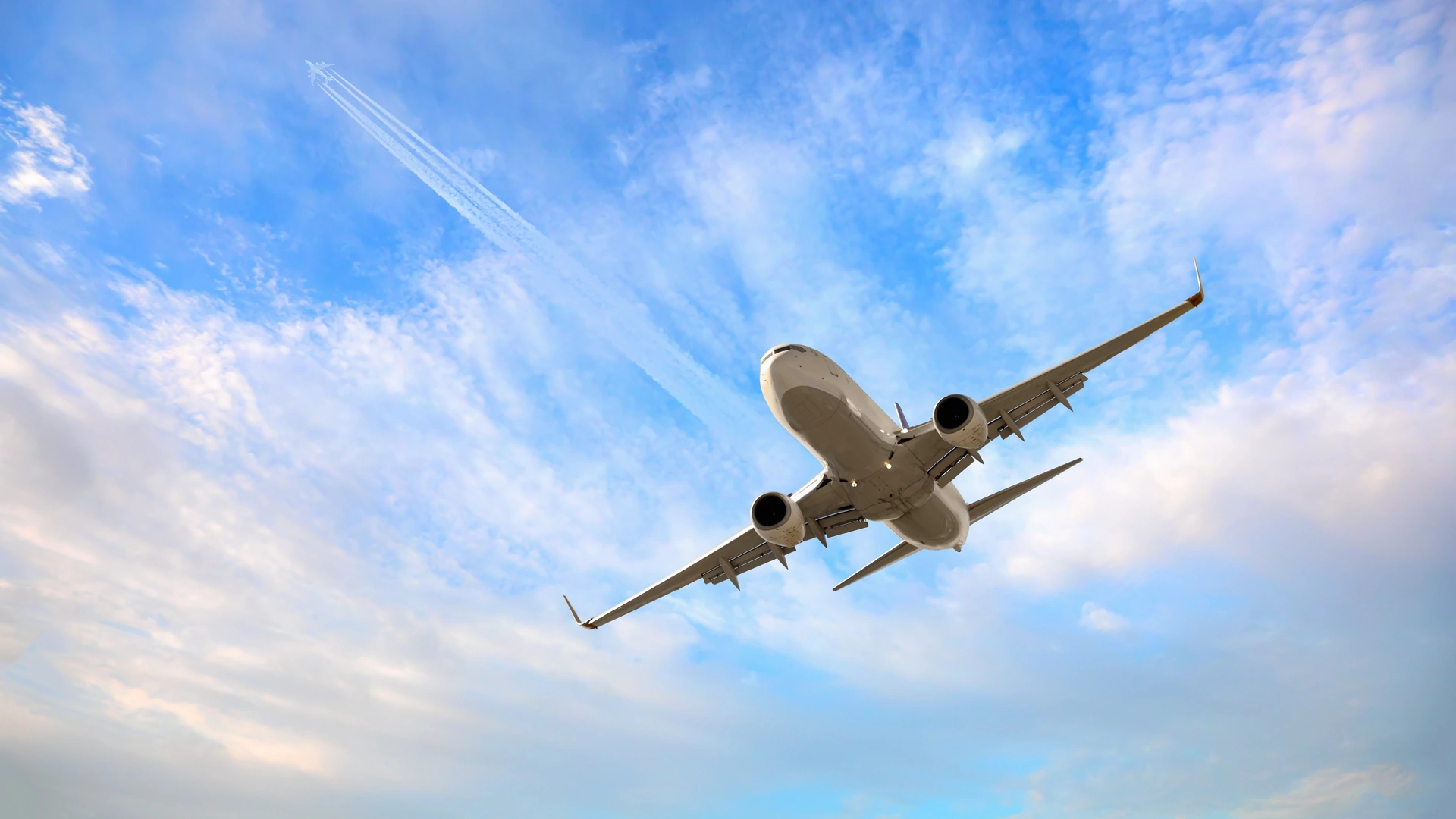 White passenger airplane flying in the sky amazing clouds in the background - Travel by air transport