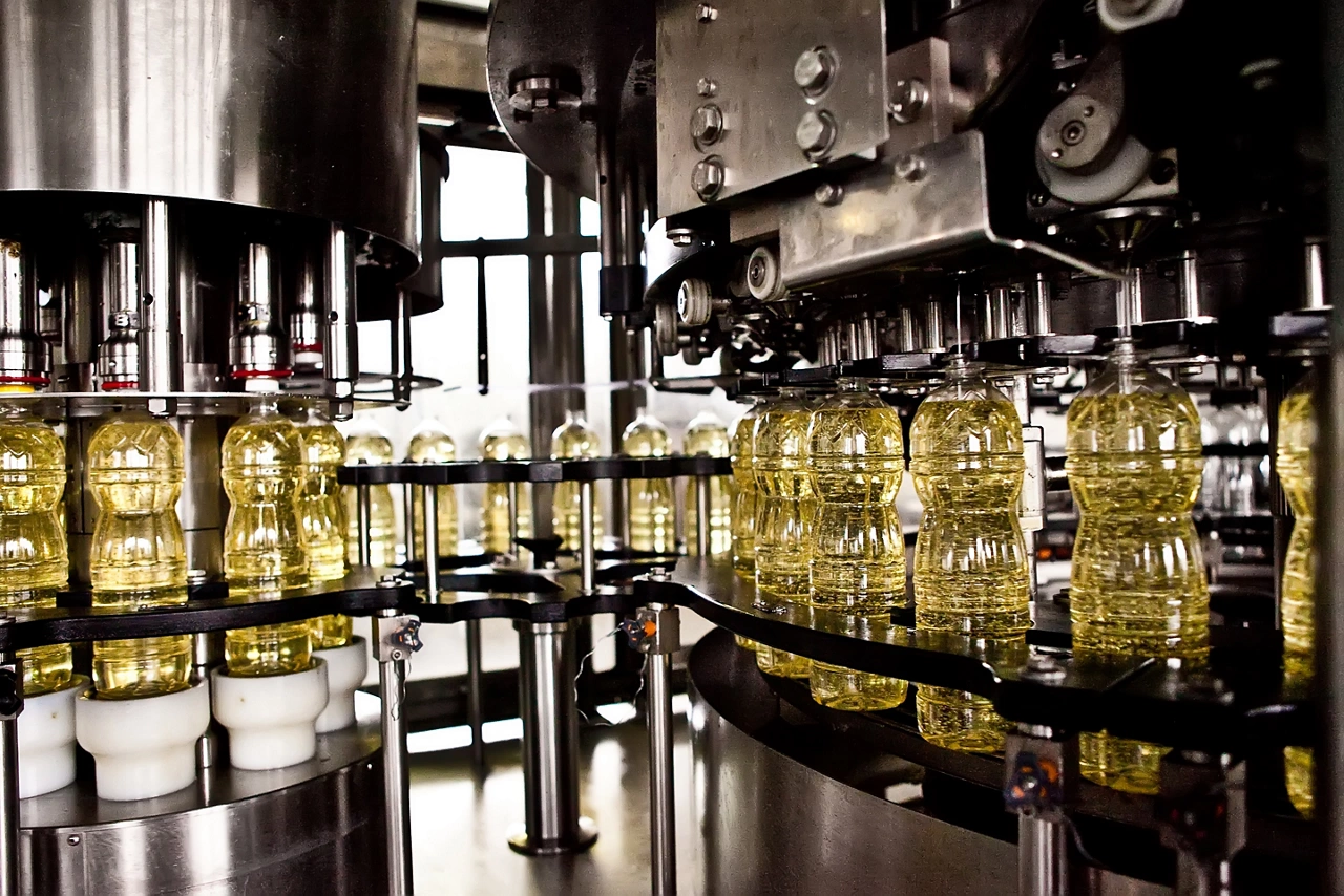 Sunflower oil in the bottle moving on production line. Shallow dof.