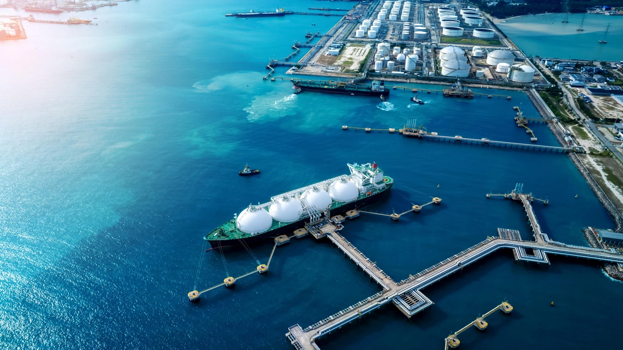 LNG (Liquified Natural Gas) tanker anchored in Gas terminal gas tanks for storage. Oil Crude Gas Tanker Ship. LPG at Tanker Bay Petroleum Chemical or Methane freighter export import transportation and logistics