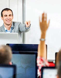 Rear view of group of people at a computer class. Focus is on teacher pointing at woman with raised hand.

[url=http://www.istockphoto.com/search/lightbox/9786738][img]http://dl.dropbox.com/u/40117171/group.jpg[/img][/url]